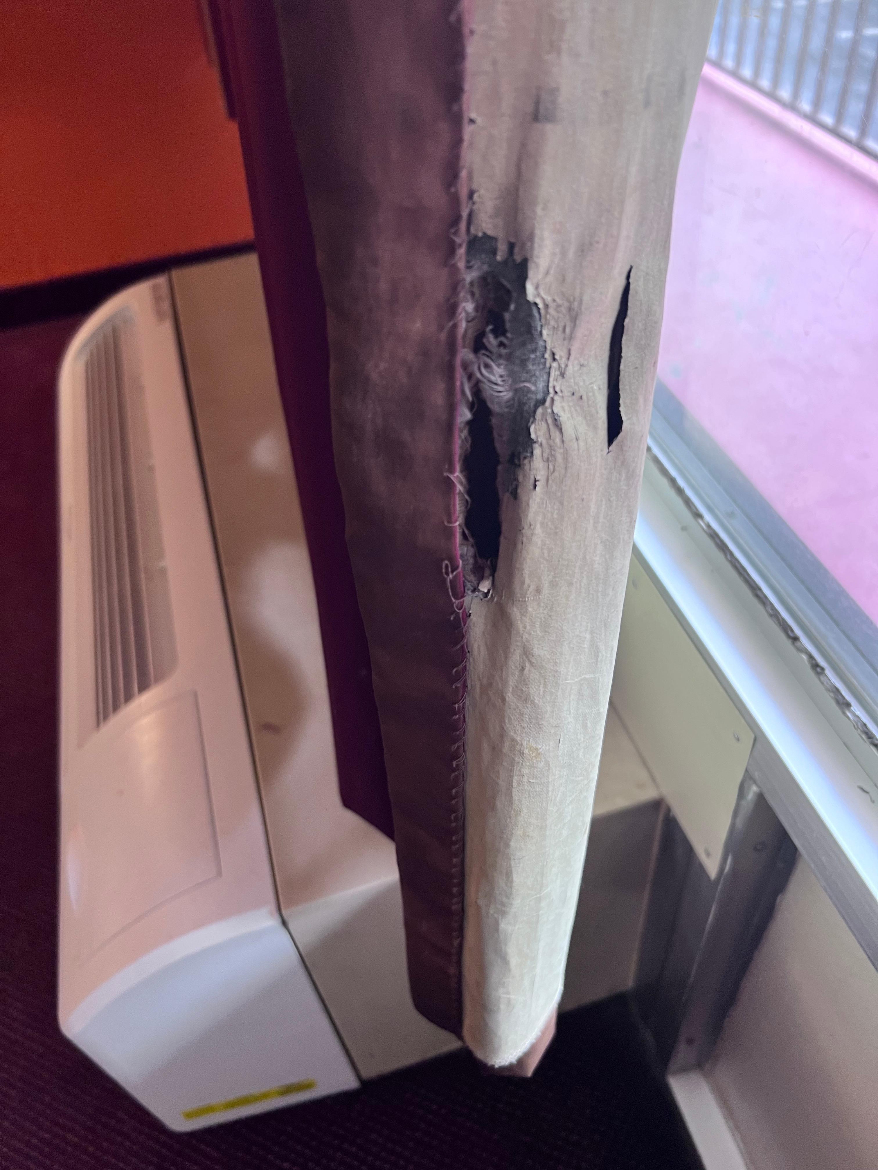 Giant hole ripped in the curtain.