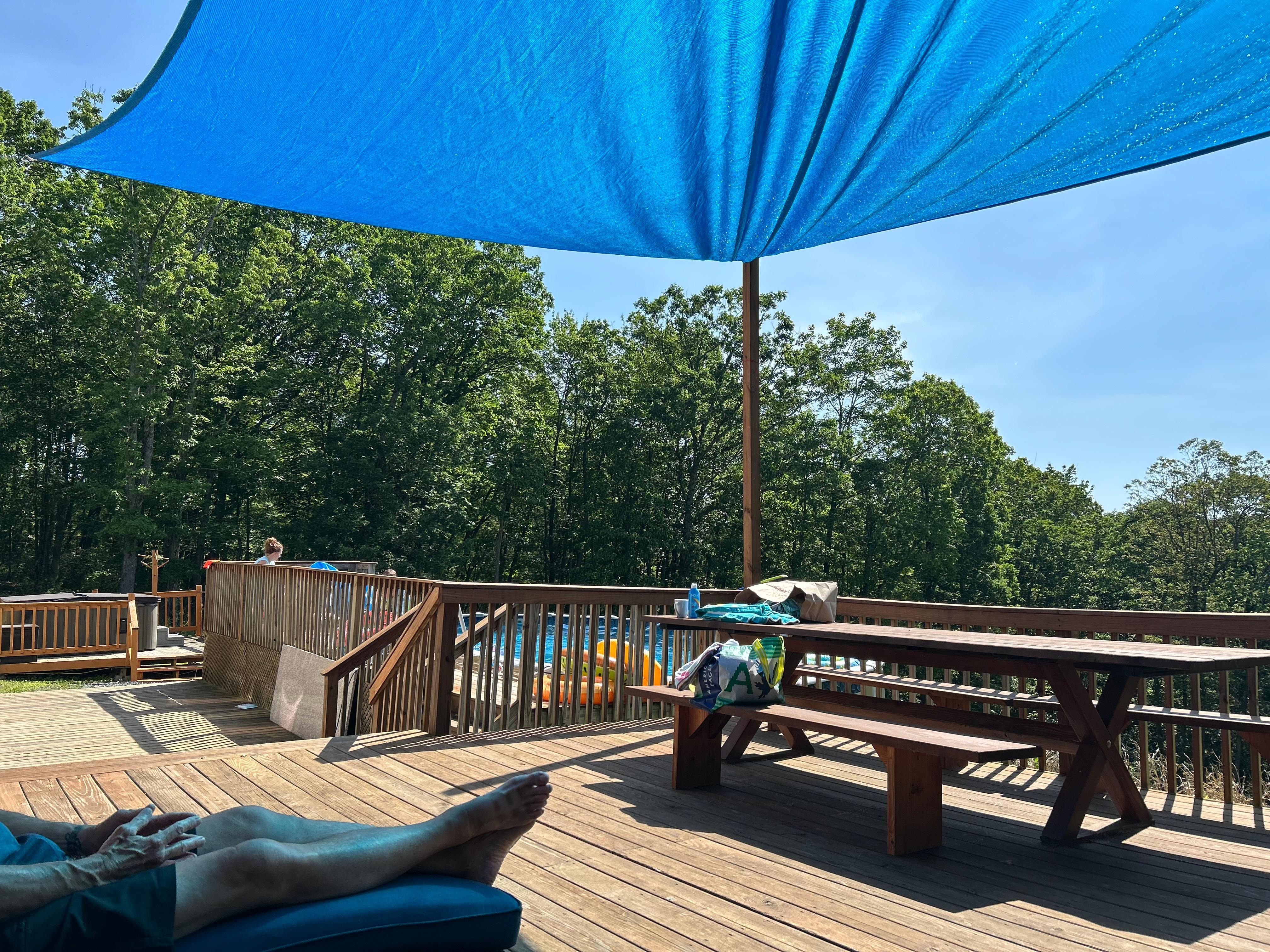 The deck overlooking the pool and sloping back yard.