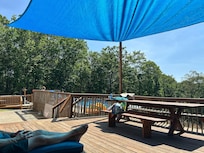 The deck overlooking the pool and sloping back yard.