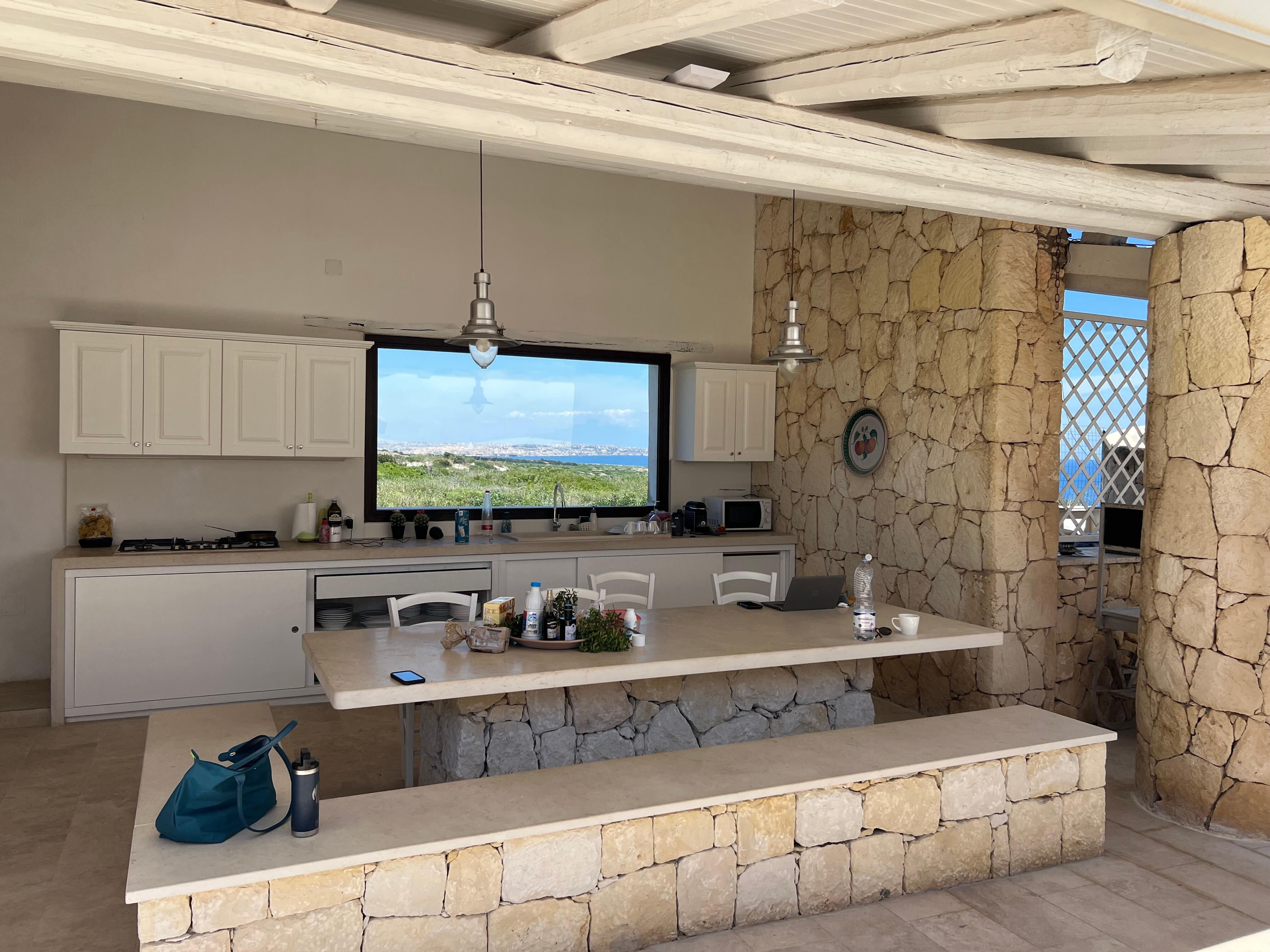 The outdoor kitchen with huge stone table 