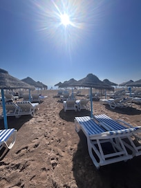 Relaxing on the beach. Umbrellas and chairs available from a local vendor for a fair price.