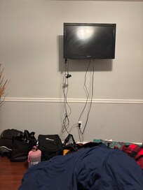 Exposed wire in an office turned bedroom.  No closet.