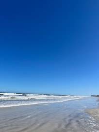 Clean and empty beach right outside the condo property.