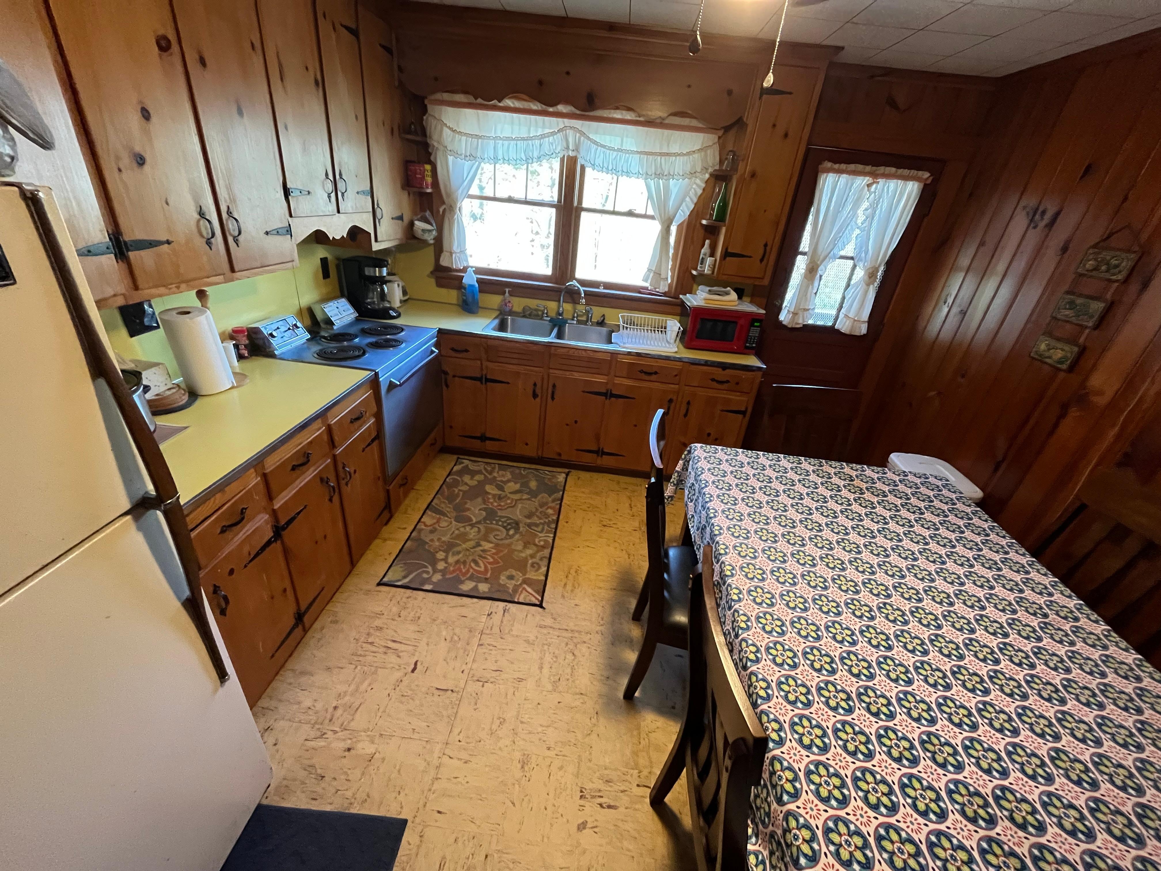 Rustic, working kitchen with access to back deck