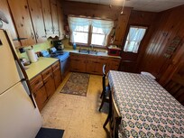 Rustic, working kitchen with access to back deck