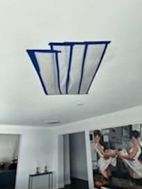 Hole in the ceiling of the living room, covered only with plastic and duct tape, leaking all weekend