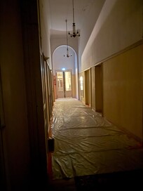 Hallway leading to the apartment covered by construction paper.