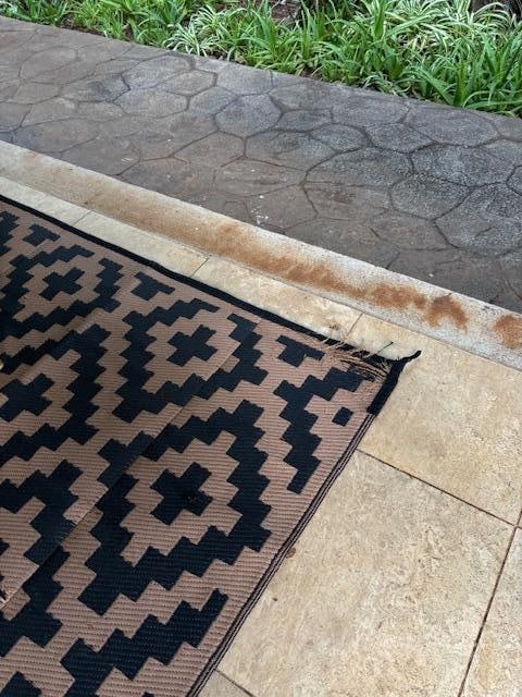 old worn out rug on the patio