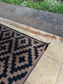 old worn out rug on the patio