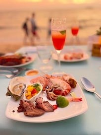 Resort seafood dinner on beach.