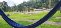 View from the cabin onto the grounds. Hammock and chairs on the porch!