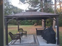 Cute back patio with a pellet grill bring your own pellets.
.