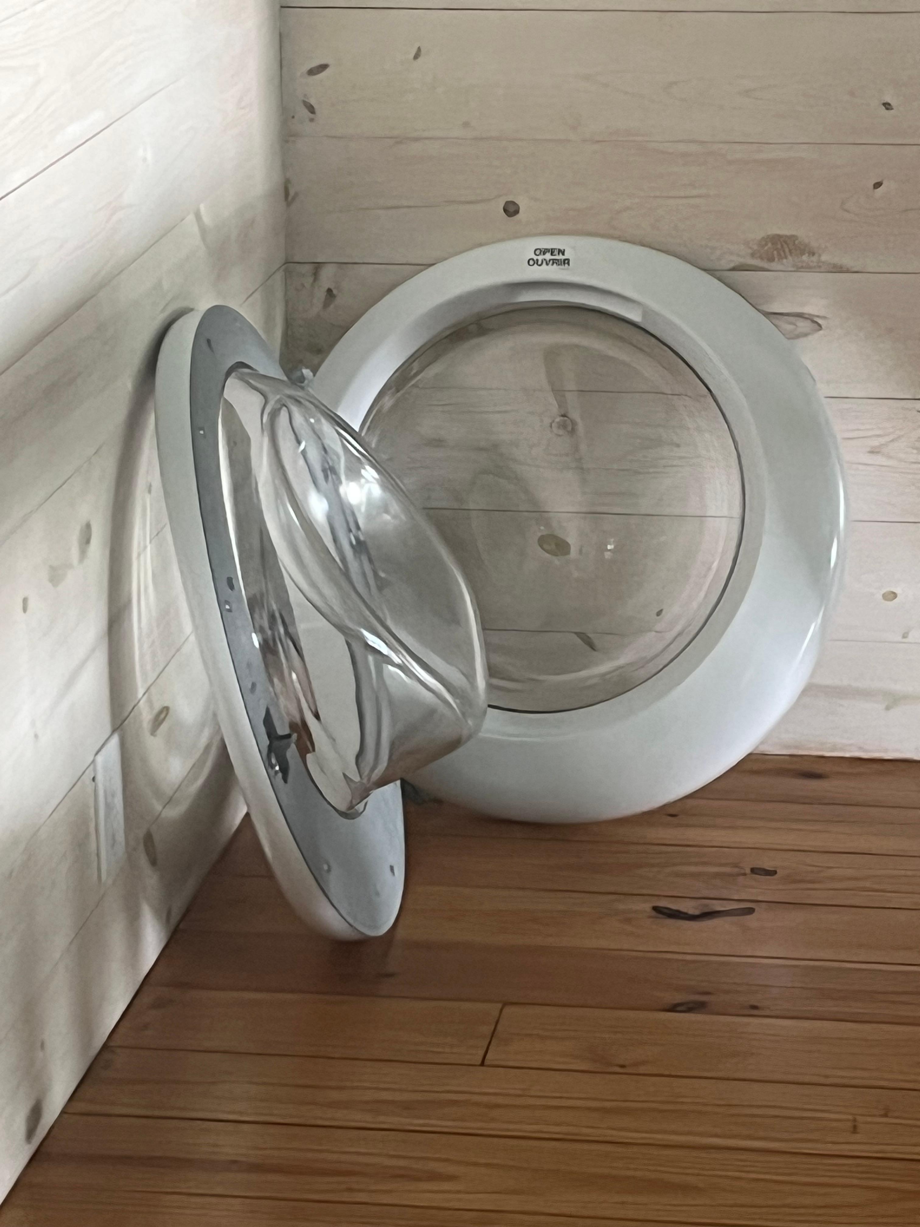 Dissembled washer door left in dining room