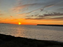 Sunset over the San Juan Islands from the living room balcony.