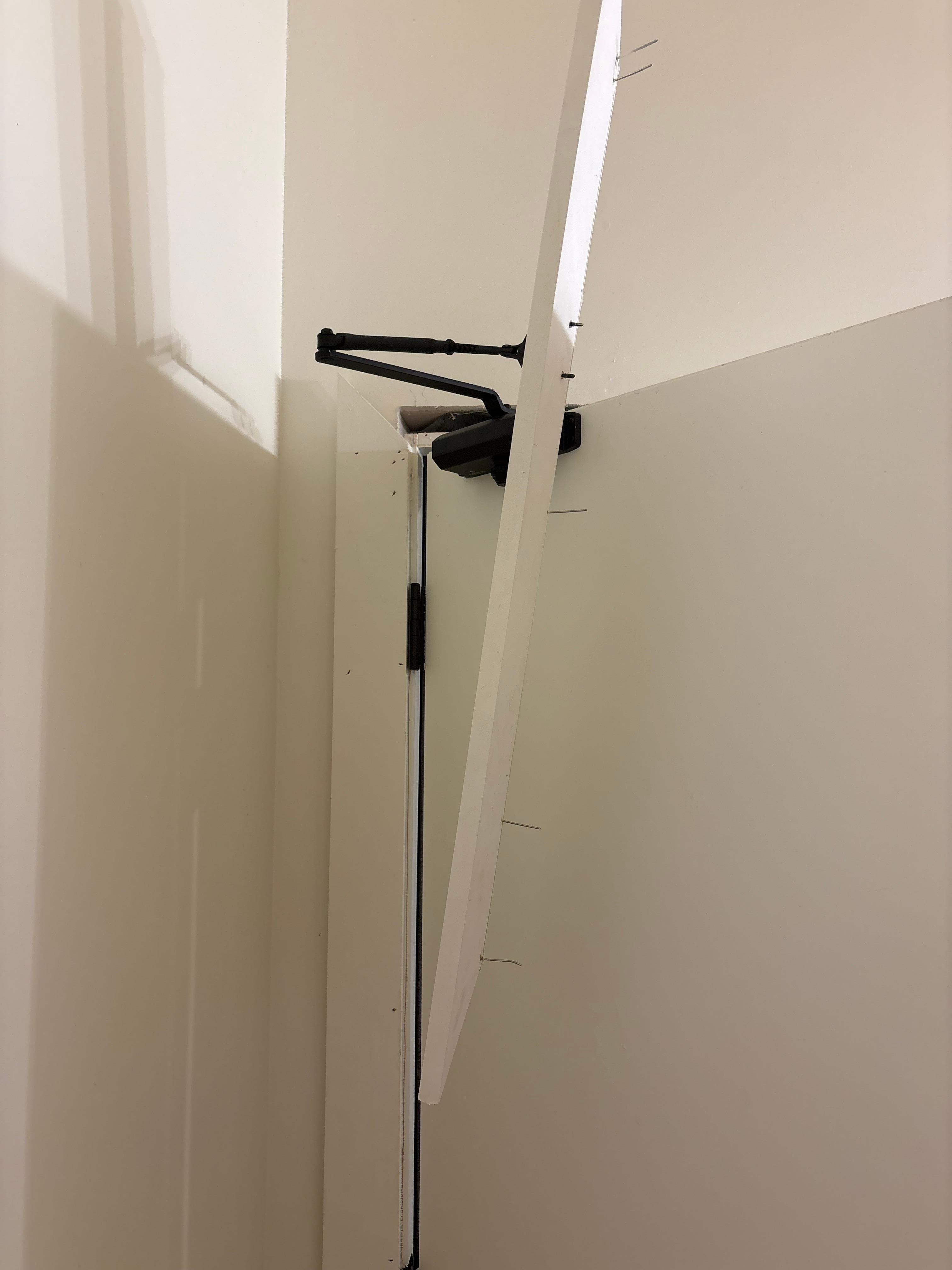 In pool bathroom. Exposed nails. Broken door closer. 