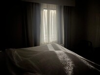 Light that came into the room from the parking lot. The heavier curtains on the outside of sheers were inoperable.