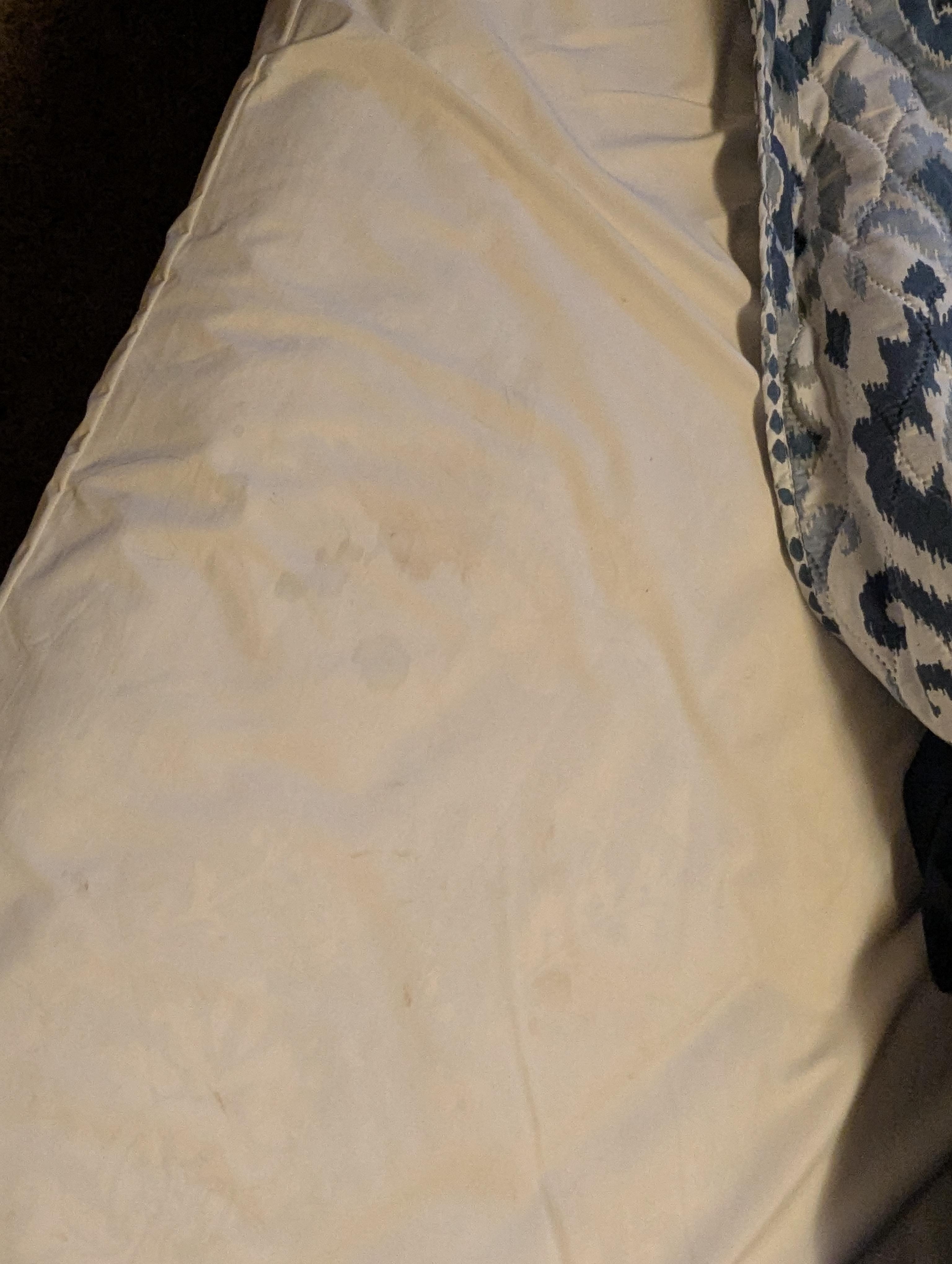 Worn thin mattress with dirty mattress cover 