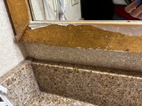 Peeling mirror above sink