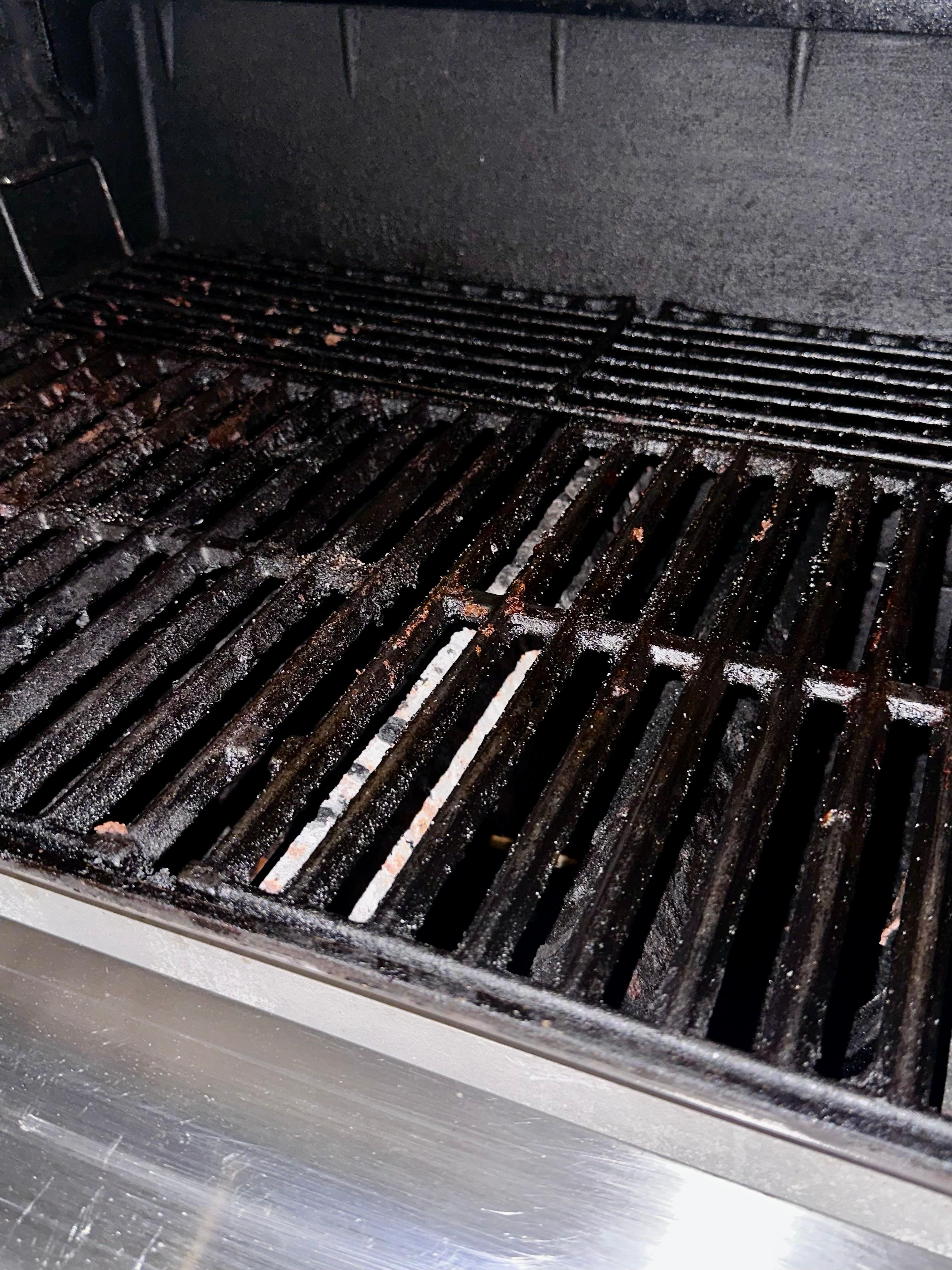 Fully loaded grease inside grill. Fire extinguisher underneath grill was empty. Broken glass across rocks outside of this. 
