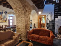 The living and dining rooms are separated by these amazing brick arches. The spiral staircase is very solid and accessible to young and old alike.