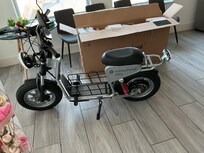 The living room and kitchen contain all three of our scooters