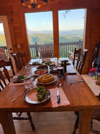 The cabin offers indoor dining with a magnificent view of the Smoky Mountains.