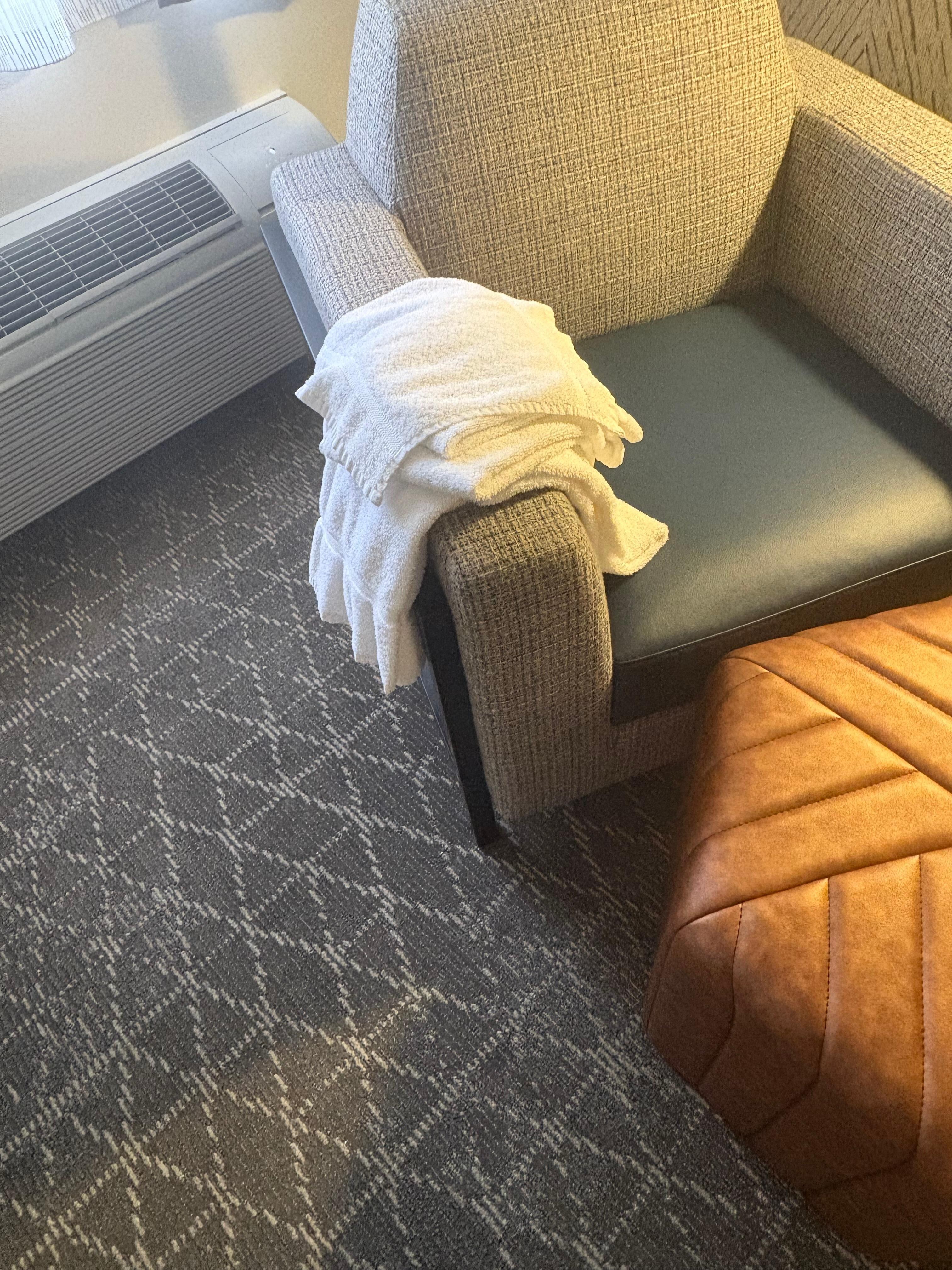 Dirty towels left on chair.
