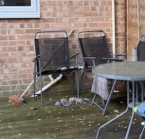 Outdoor dining area - green mouldy furniture, dirty socks and towels left