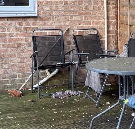 Outdoor dining area - green mouldy furniture, dirty socks and towels left
