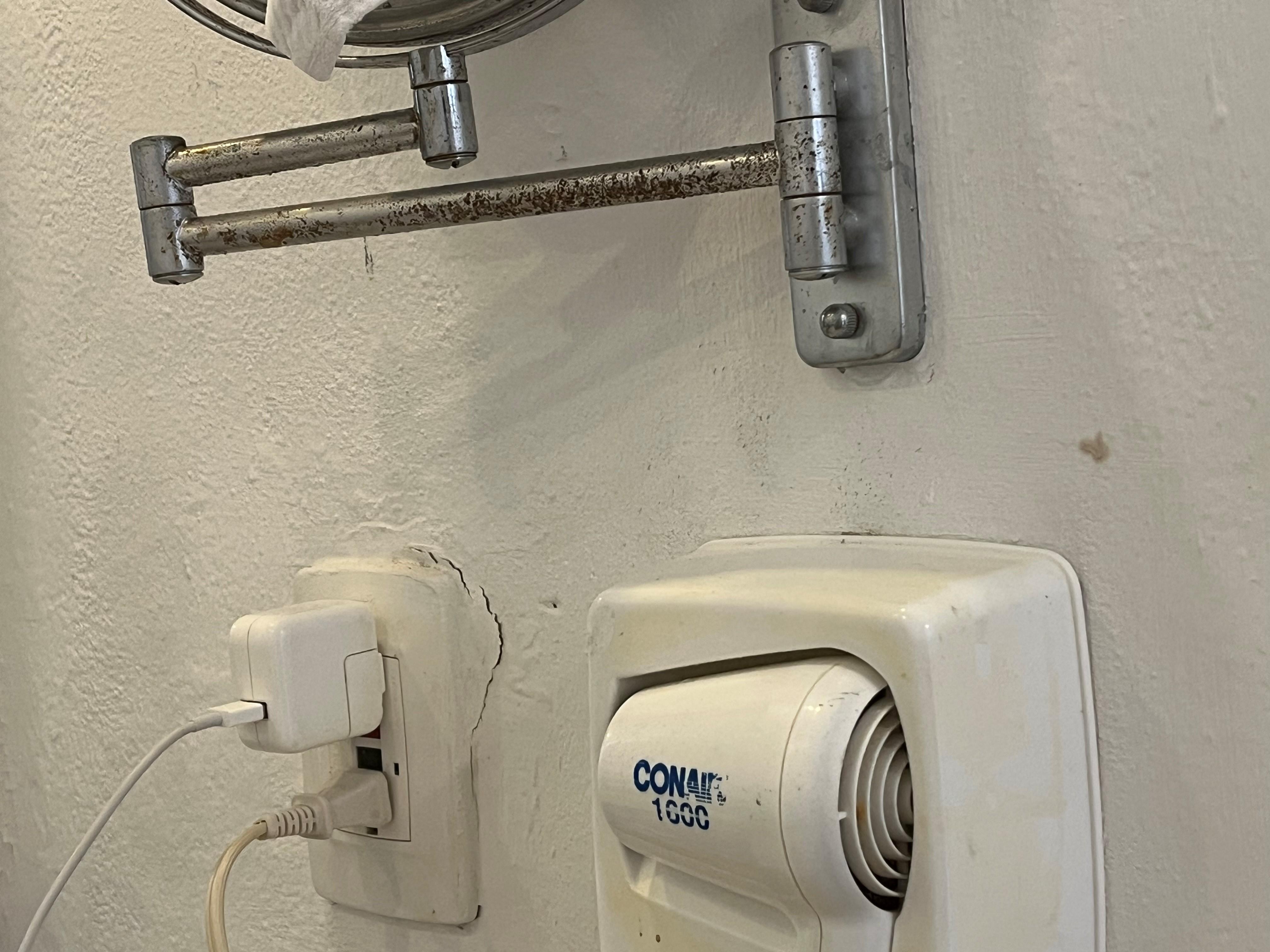 rusty mirror, cracks around outlet