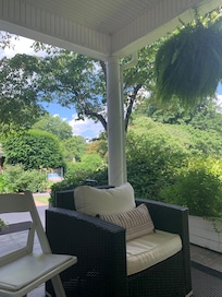 Side porch pool beyond trees.