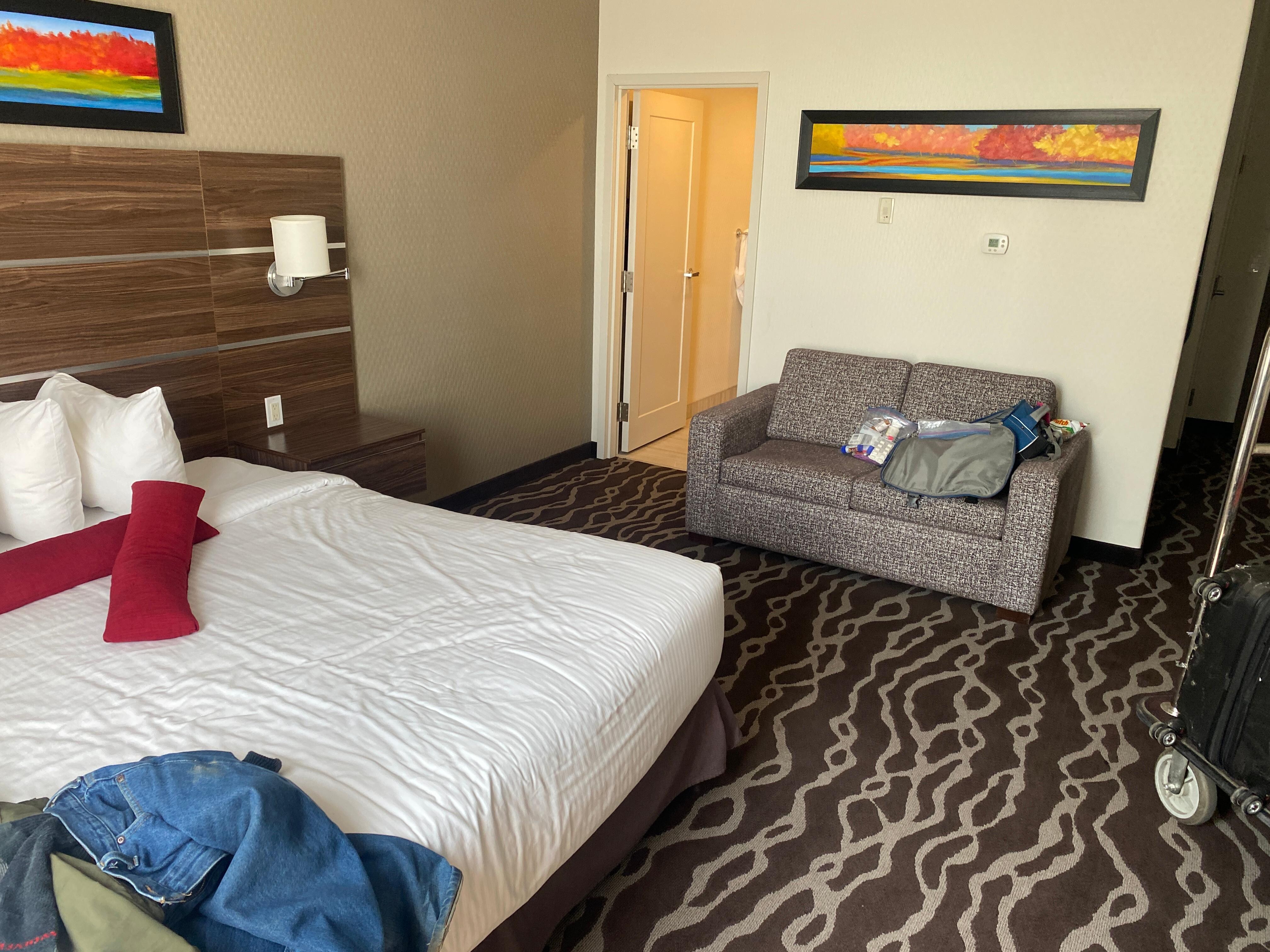 Spacious sleeping are with small table and a desk 