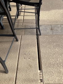 Careful with chairs on patio. Recommend replacing the drain cover for this slot.
