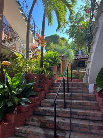 To the left of our room. Kitchen and dinning area at top of stairs.