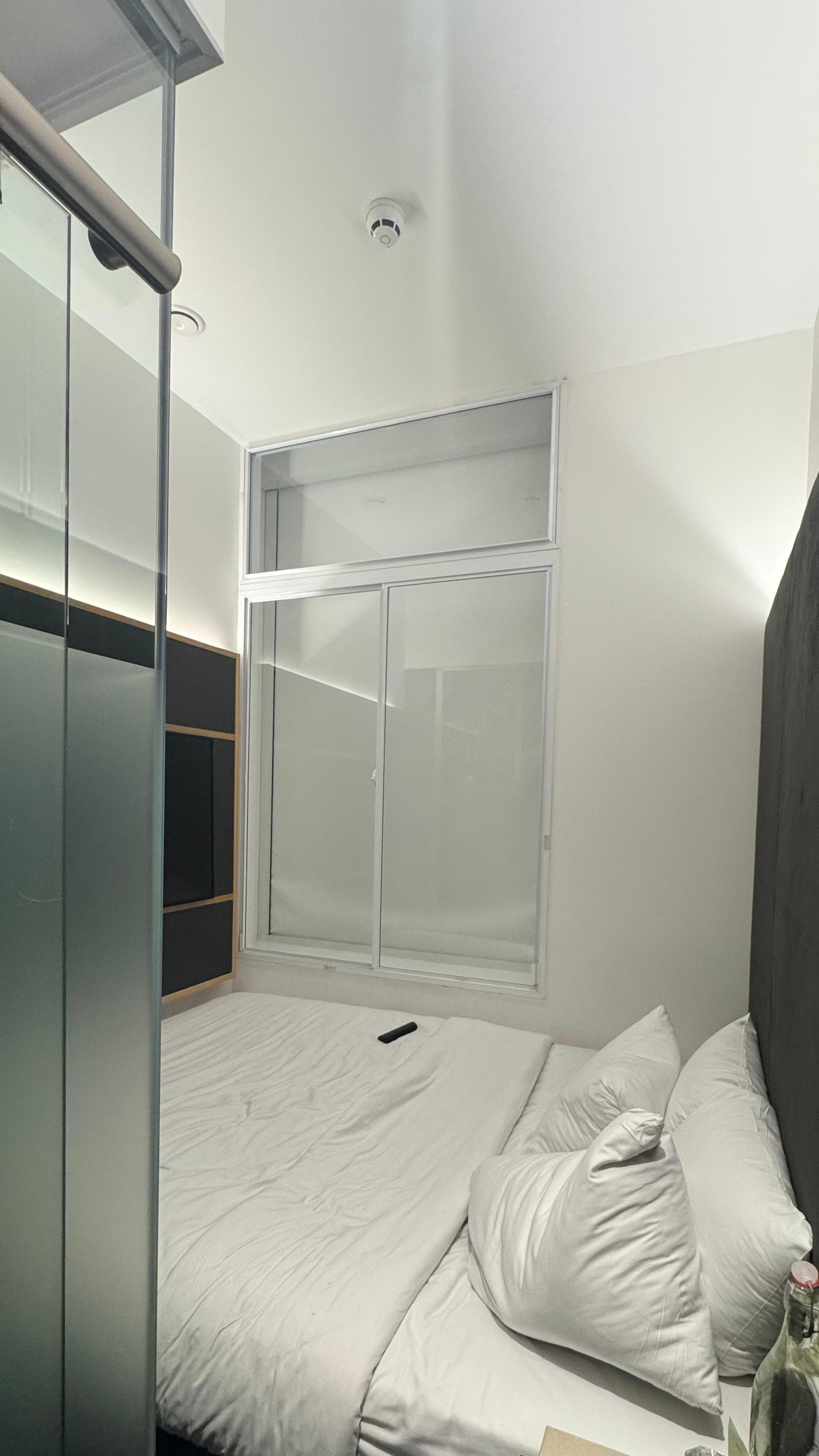 Bedroom = entrance next to glass walled shower/toilet,  shower next to bed & bed next to wall (no gaps). Have to climb past stool/bedside table to access bed. Window was internal with no outlook when blind raised.