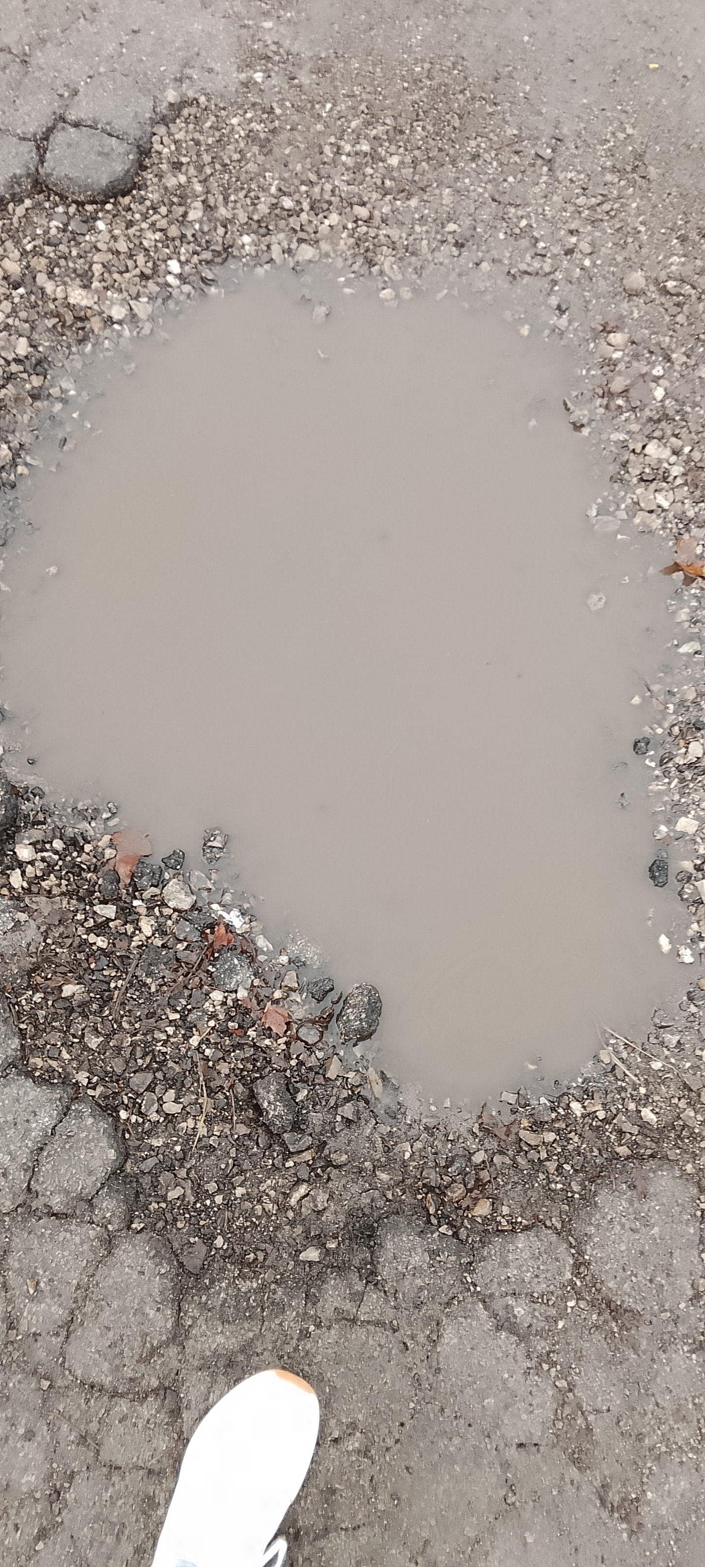 Deep potholes in parking lot. 