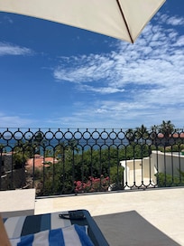 Enjoying the view from the comfy lounge chairs under the umbrella.