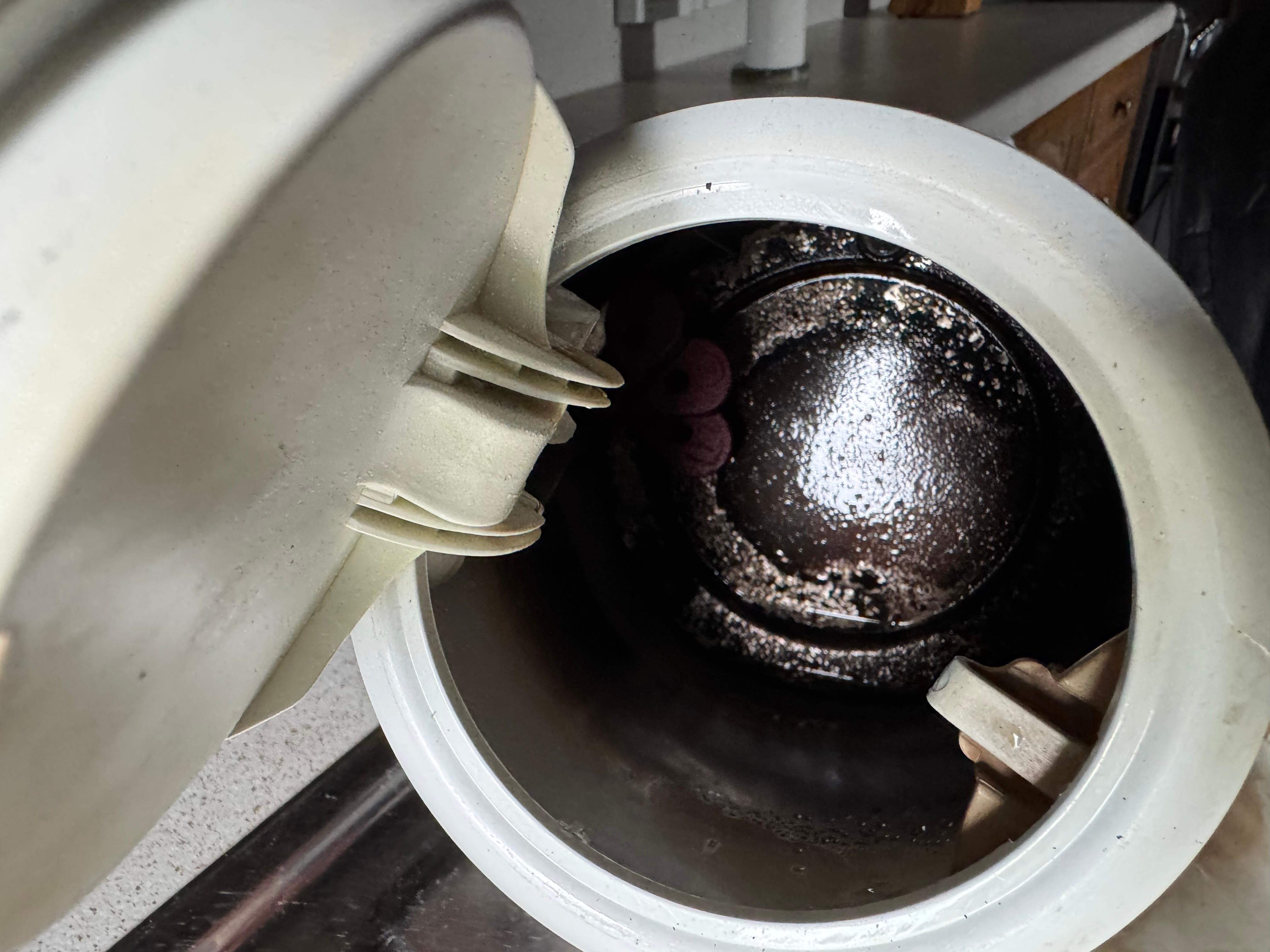 Tea pot with dried debris in the bottom and black on the sides
