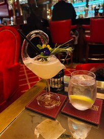 Pretty drink in a swan glass. Very creative bartender.