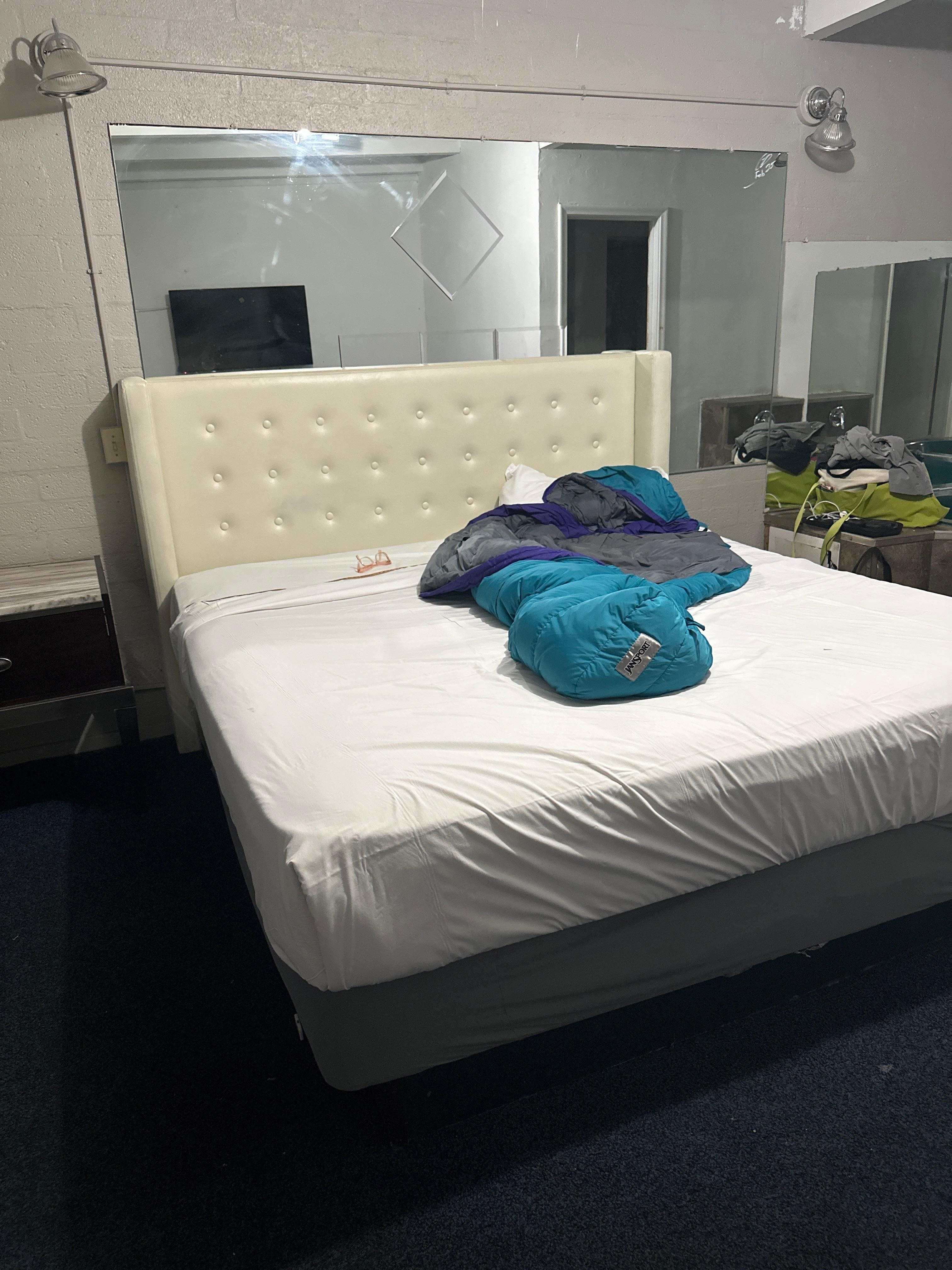 Bed lacking a flat sheet between blanket and mattress. 