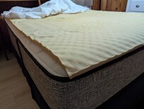 Old stained topper. Completely flattens under any weight.