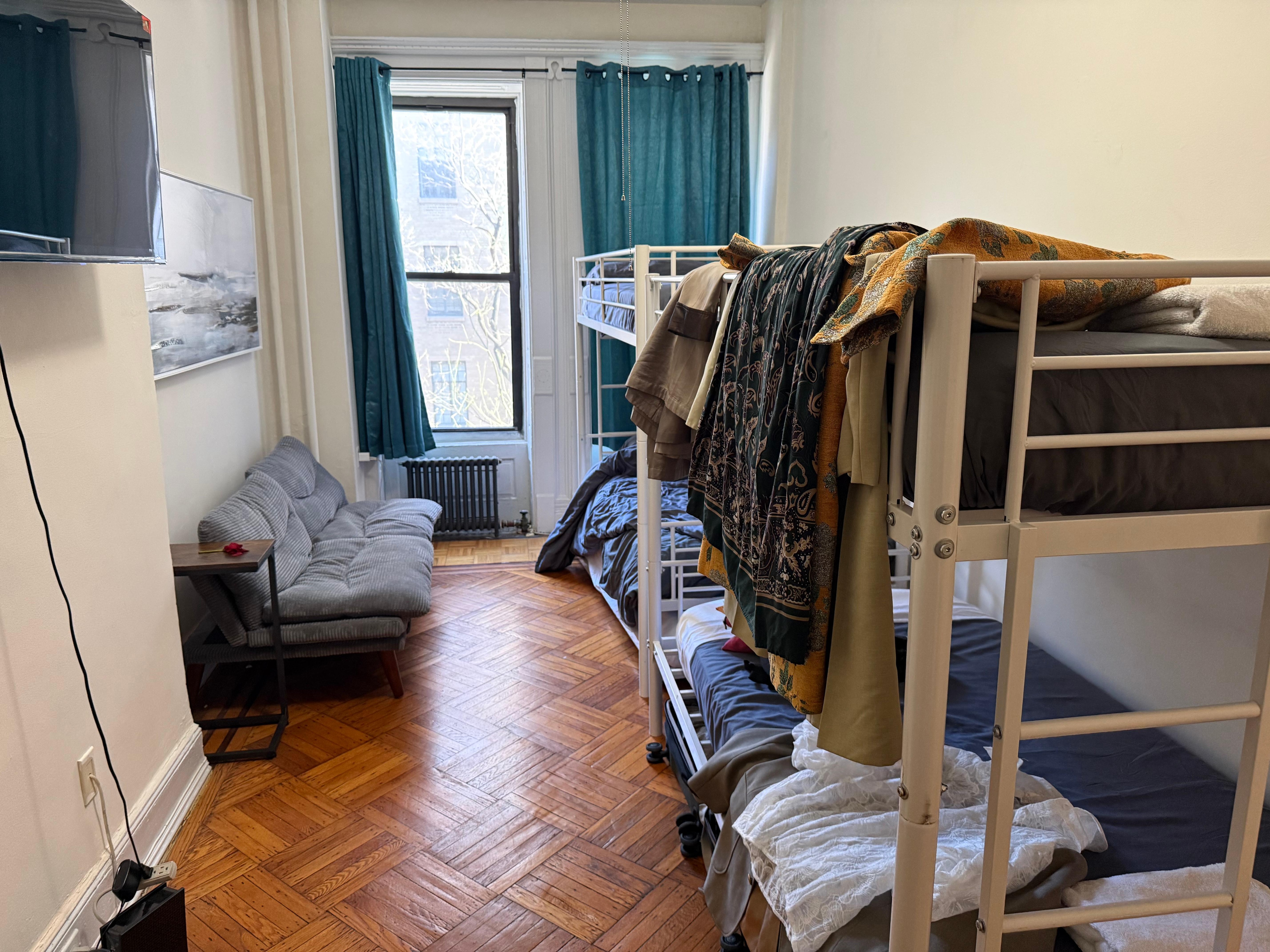 One long narrow room with bunk beds and sofa bed