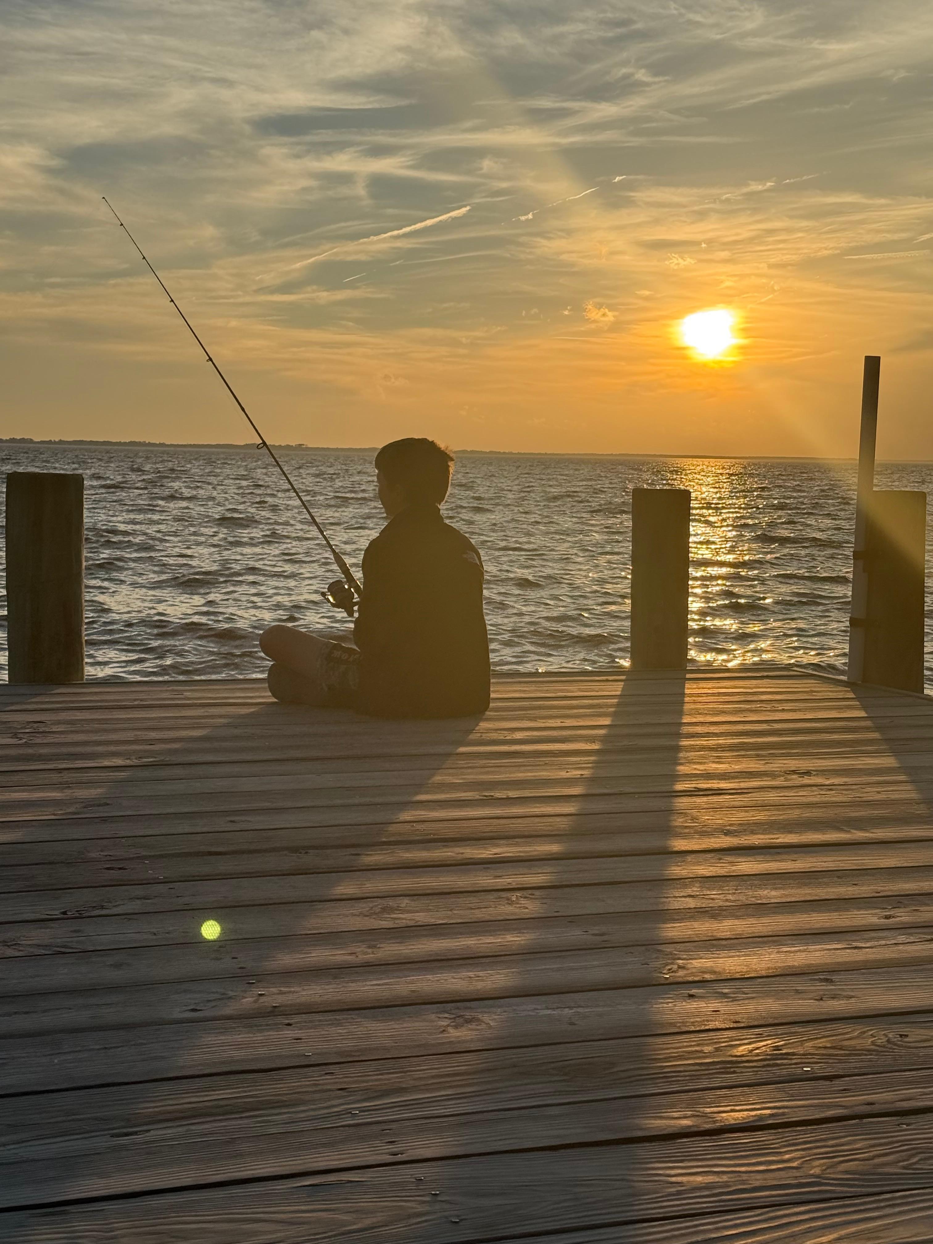 Our son fishing and praying he catches a fish off the dock.