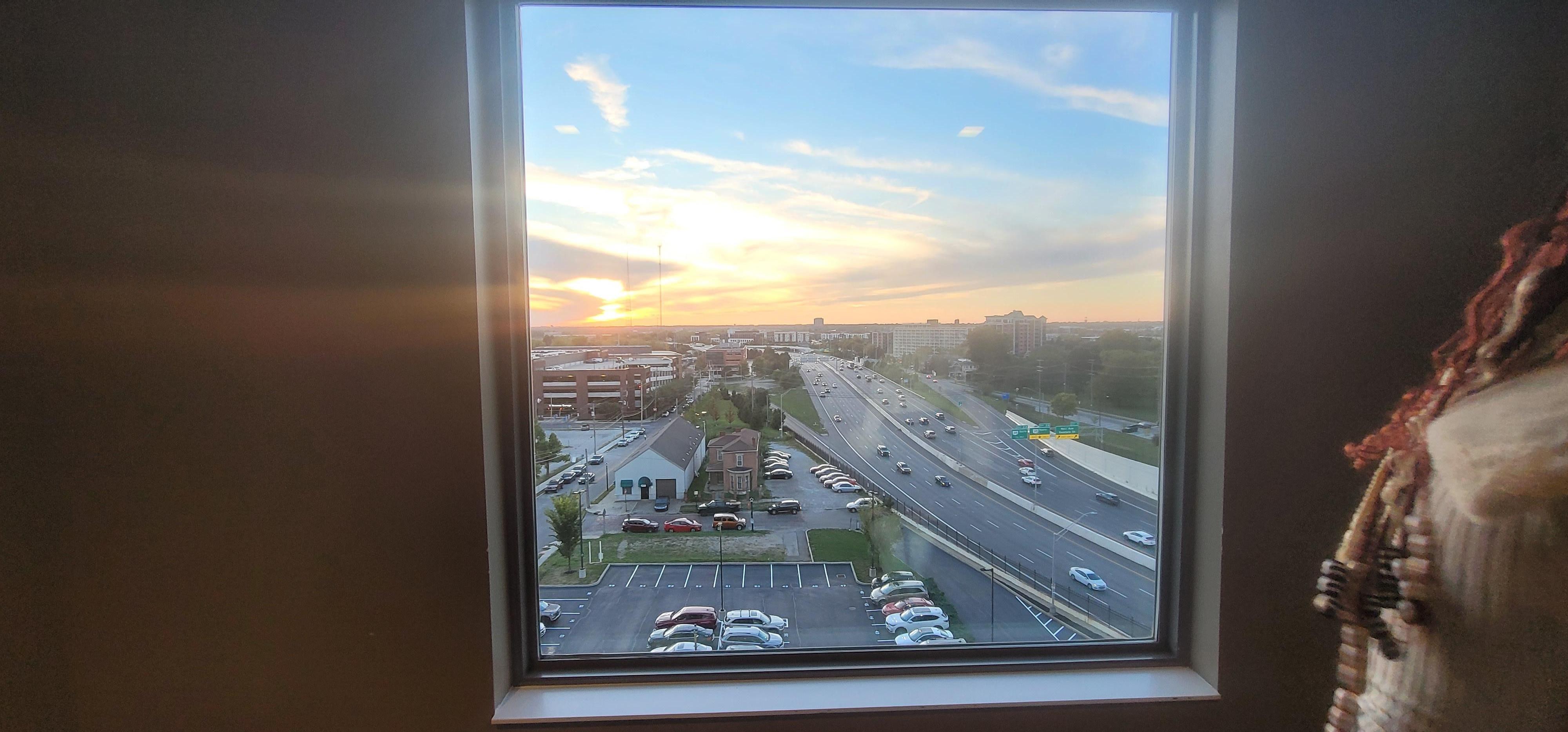 Street view by elevators on the 7th floor as the sun is going down (parking lot).