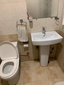 Bathroom, no shelves, slow ti get hot water
Tiny space