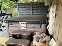 Nice private hot tub with towels and robes.