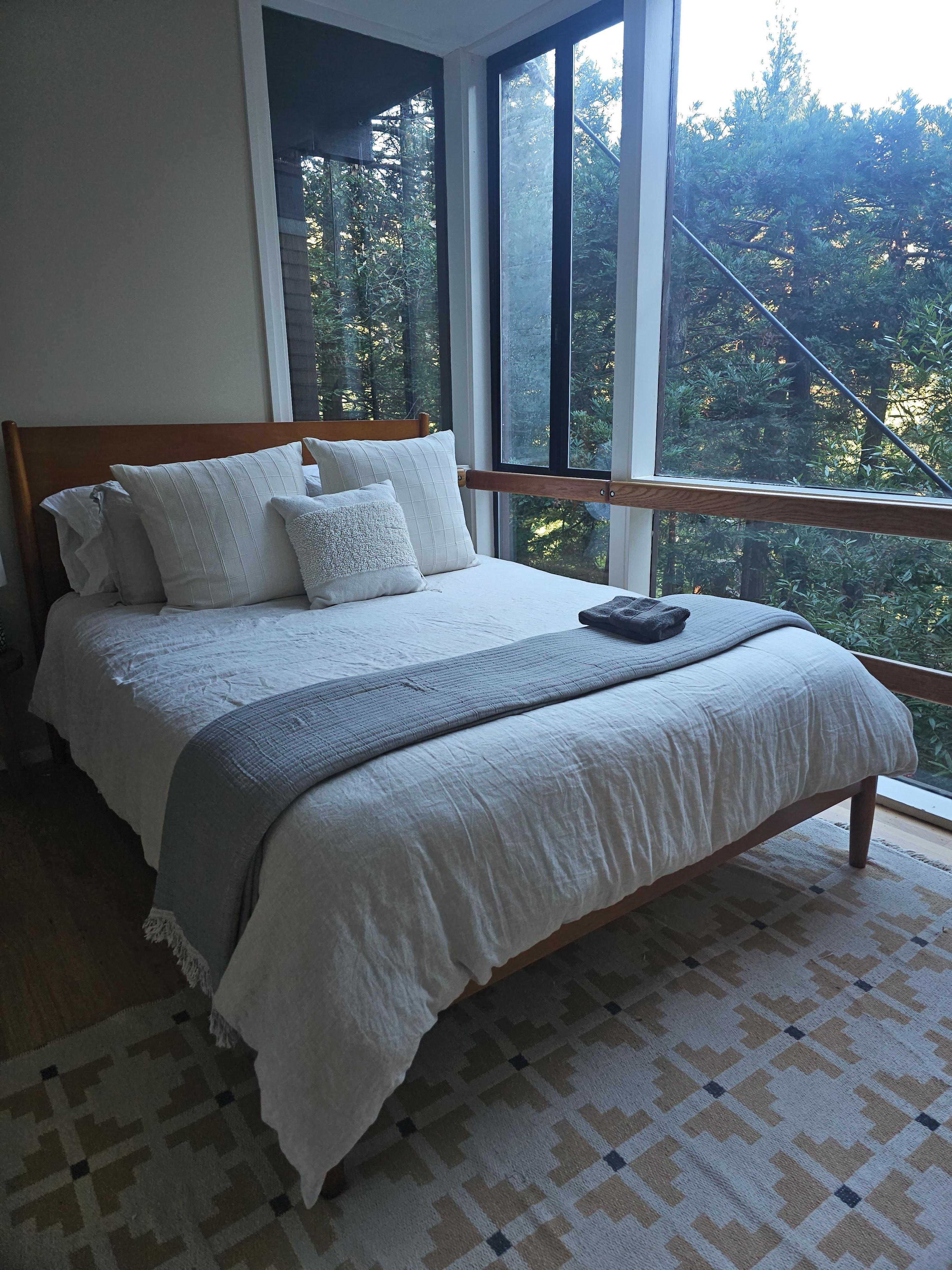 A clean comfy bed awaits with spectacular views. 