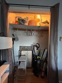 Upstairs bedroom closet also unorganized, with some board games.