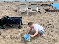 Our son playing in the sand