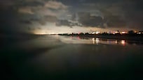 This picture on the beach looking towards downtown St. Augustine- was really dark out. We could barely see each other unless we stood close. No moon was out. My camera just picked up the lights enough to catch the "scene" and very low tide.